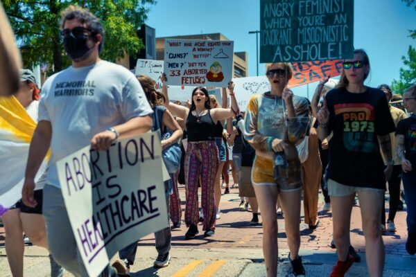 Roe vs. Wade: America’s Holocaust, 46 Million Victims And Counting. A diverse crowd protesting for women's rights and healthcare access in a peaceful demonstration.